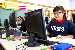 Melizza Gonzalez, left, and Ana Olvera work in the school's computer lab. Founded by the School Sisters of Notre Dame in 1996, Notre Dame Middle School serves primarily at-risk Latina students. (Submitted photo courtesy Notre Dame Middle School)