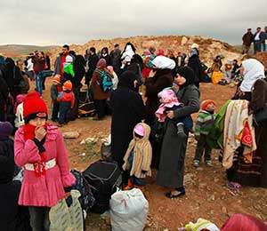 Syrian refugees rest after they crossed into Jordan with their families from Syria near Al Mafraq Feb. 18. Cardinal Robert Sarah, president of the Pontifical Council Cor Unum, praised the response of Catholic agencies to Syrian refugees flowing into Jordan in an address to aid workers Feb. 20. (CNS photo/Muhammad Hamed, Reuters)