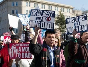 People take part in the March for Marriage outside the Supreme Court building in Washington March 26 as justices heard arguments in a case challenging California's same-sex marriage ban, the 2008 voter-approved ban known as Proposition 8. The next day the justices were to hear arguments in a case involving the Defense of Marriage Act, which defines marriage as "a legal union between one man and one woman as husband and wife." (CNS photo/Nancy Phelan Wiechec)