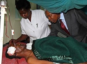 Tanzania's Vice President Mohamed Gharib Bilal visits Mount Meru Hospital and consoles a man injured during an explosion at St. Joseph Mfanyakazi Catholic Church in Arusha, Tanzania, May 5. The bombing left at least two people dead and dozens injured. (CNS photo/Reuters)