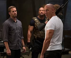 Paul Walker, Dwayne Johnson and Vin Diesel star in a scene from the movie "Fast & Furious 6." The Catholic News Service classification is L - limited adult audience, films whose problematic content many adults would find troubling. The Motion Picture Association of America rating is PG-13 - parents strongly cautioned. Some material may be inappropriate for children under 13.(CNS photo/Universal)