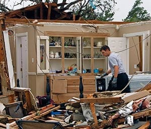 A rescue worker combs through debris May 16 after tornadoes swept through the town of Granbury, Texas, late May 15. At least six people were killed and about 100 injured as three tornadoes ripped through a stretch of Texas near the Dallas-Fort Worth area, destroying a number of homes, authorities said. (CNS photo/Richard Rodriguez, Reuters)