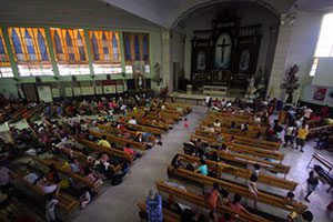 Families displaced by flooding occupy a church serving as an evacuation center in Quezon City, Philippines, Aug. 21. Hundreds of thousands of people in metro Manila and surrounding areas have been affected by heavy monsoon rains and flooding. (CNS photo/ Al Falcon, Reuters)