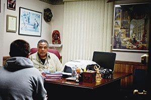 Willie Stovall, a social worker at the Carmelite Home for Boys, listens during a meeting with a client at the home. (Catholic Herald photos by Juan C. Medina)