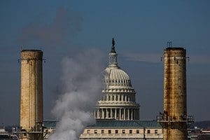 The dome of the U.S. Capitol is seen behind the smokestacks of the only coal-burning power plant in Washington in this March 10, 2014, file photo. (CNS photo/Jim Lo Scalzo, EPA)