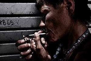 In this Sept. 3, 2014, file photo, a drug addict smokes drugs in the city of San Jose, Costa Rica. (CNS photo/Jeffrey Arguedas, EPA)