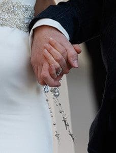 A newly married couple hold rosaries in their hands as they leave Pope Francis' general audience in St. Peter's Square at the Vatican Feb. 24. Pope Francis' postsynodal apostolic exhortation on the family, "Amoris Laetitia" ("The Joy of Love"), was to be released April 8. The exhortation is the concluding document of the 2014 and 2015 synods of bishops on the family. (CNS photo/Paul Haring)