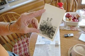 William Condon holds a picture of his brother Thomas driving a Harley-Davidson motorcycle with a friend on the back. According to William, his brother bought the motorcycle after he finished Air Force boot camp. Thomas died in 1952 while flying to Elmendorf Air Force Base in Alaska. His remains were found in 2012. (Catholic Herald photo by Ricardo Torres)