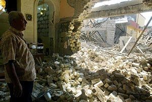 An Iraqi man inspects the damage in 2011 at a Catholic church after attacks in Kirkuk. Despite predictions that Christianity could be wiped out of his war-torn homeland within five years, Chaldean Archishop Yousif Mirkis of Kirkuk said he believes in God's ultimate preservation. (CNS photo/Khalil Al Anei, EPA)