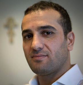 Omar al-Muqdad, a Syrian refugee who resettled in the United States in 2012 with the help of the U.S. bishop's Migration & Refugee Services and Catholic Charities of Arkansas, is pictured in this April 15 photo in Washington. He has seen both sides of the refugee crisis, including helping Iranian refugees years before he fled his homeland. (CNS photo/Chaz Muth)