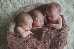 Sidney, Sophe-Elizabeth and Sebastien, are the adopted triplets of Kevin and Cari Campbell. The children were baptized Easter morning at Resurrection Church in Dubuque, Iowa. (Photo courtesy Abbi Triphan Photography)