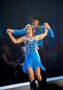 Fr. Matthew Widder, shared pastor of Holy Name of Jesus and St. Clement parishes, Sheboygan, dancing a Texas two-step routine with Susan Alby, won the 2016 Movers and Shakers Gala championship on May 14, a benefit for Lakeland College, Sheboygan. (Photo courtesy of Lakeland College)