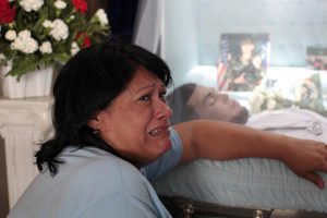 Lucyvette Padro mourns next to the body of her son, Angel Candelario Padro, during his wake June 17 in his hometown of Guanica, Puerto Rico. Candelario was of the victims of the June 12 mass shooting at the Pulse nightclub in Orlando, Fla. (CNS photo/Alvin Baez, Reuters)