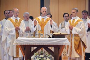 Jesuit Fr. Vincent Strand, center, with his brothers Fr. Luke Strand, left, and Fr. Jacob Strand, celebrates a Mass of Thanksgiving on Sunday, June 5 at St. Bruno Parish, Dousman. Fr. Vincent was ordained a Jesuit priest by Archbishop Jerome E. Listecki the day before, Saturday, June 4, at Gesu Church, Milwaukee. (Catholic Herald photo by John Kimpel)
