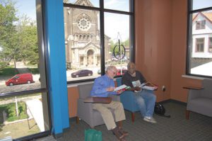 Carl Stehling, an Adult Learning Center volunteer, left, tutors Mark Caldwell in the new TechForce Training Center located on the St. Francis of Assisi Parish, Milwaukee, campus on Tuesday, May 24. (Catholic Herald photo by Ricardo Torres)