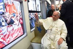 Pope Francis waves to people lining a street as he rides a tram to reach the World Youth Day welcoming ceremony with young people in Blonia Park in Krakow, Poland, July 28. (CNS photo/Alessia Giuliani, pool) See POPE-POLAND-WYD-WELCOME July 28, 2016.