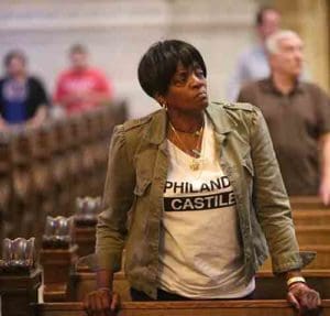 Sharon James-Abba listens to Archbishop Bernard A. Hebda of St. Paul and Minneapolis during a July 8 Mass for peace and justice at the Cathedral of St. Paul. The Mass was offered in response to the July 6 shooting death of St. Paul resident Philando Castile by a police officer. (CNS photo/Dave Hrbacek, The Catholic Spirit)