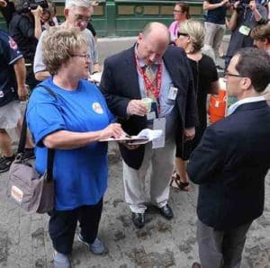 Sr. Julie Ann Krahl, a member of the Congregation of the Sisters of St. Agnes in Fond du Lac, collects information from bystanders July 18 outside the Republican National Convention in Cleveland. (CNS photo/William Rieter)
