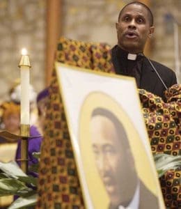 During the 14th annual memorial prayer service for Rev. Dr. Martin Luther King Jr. at All Saints Parish, Milwaukee, Jan. 17, 2005, Fr. Bryan Massingale leads a commissioning rite for participants willing to accept the call to discipleship. (Catholic Herald file photo by Sam Lucero)
