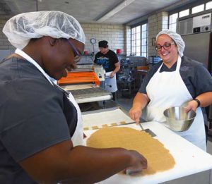 Benedictine Sr. Romaine Kuntz carries a tray of finished Hildegard cookies Sept. 13 at a monastery run by the Sisters of St. Benedict in Ferdinand, Ind., in time for St. Hildegard’s Sept. 17 feast day. The popular product, baked from a recipe written by St. Hildegard, is shipped to buyers across the United States. (CNS photo/Katie Breidenbach)