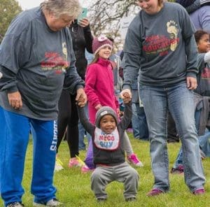 Walkers of all ages participate in a group warm-up on the grounds of Mount Mary University where the walk started and finished. (Catholic Herald photo by Peter Fenelon)