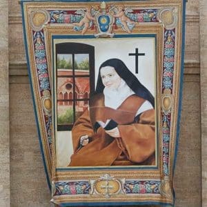 Blessed Elizabeth of the Trinity, a writer and mystic who desired a deeper understanding of God’s love, is among seven new saints to be declared by Pope Francis at the Vatican Oct. 16. Her tapestry and the others on this pages are seen on the facade of St. Peter’s Basilica at the Vatican Oct. 13. (CNS photos/Paul Haring)