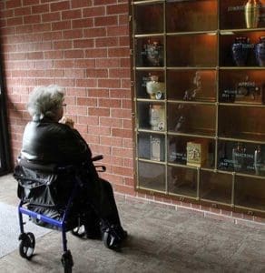 Laure Cressaty prays in front of a niche holding the cremated remains of her late husband, Joseph Cressaty, at Holy Rood Cemetery in Westbury, New York, Oct. 21, 2014. (CNS file photo/Gregory A. Shemitz) 