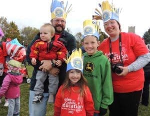 The Davis family, members of St. Katharine Parish, Beaver Dam, participate in the 2015 Soles for Catholic Education Walk at Mount Mary University, Milwaukee. Angela and John, pictured with their children, John Jr., left to right, Adelaide and Archer, travel 60 miles each way to be part of the walk. (Submitted photo courtesy Angela Davis)