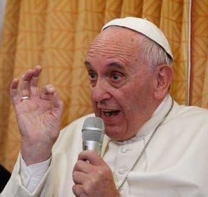 Pope Francis answers questions from journalists aboard his flight from Baku, Azerbaijan, to Rome Oct. 2. (CNS photo/Paul Haring)