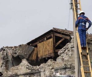 An earthquake rescue team member is seen in Amatrice, Italy, Aug. 31. Pope Francis’ raffle this year will benefit earthquake victims. (CNS photo/Massimo Percossi, EPA)