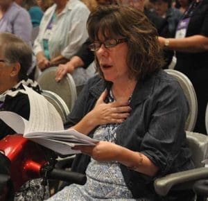 Kim Padan of Danville, Ill., sings during the Sept. 10 closing Mass of the National Council of Catholic Women convention in Indianapolis. Some 700 women from across the country attended the convention of the organization that was founded in 1920. (CNS photo/Sean Gallagher, The Criterion)
