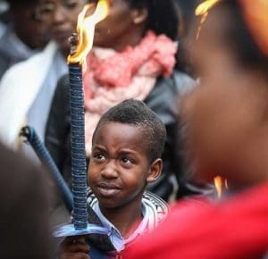 A boy takes part in a torchlight march for the victims of the Rwanda genocide, in Brussels, Belgium, in this 2014 file photo. In a letter to mark the end of the Year of Mercy, Rwanda’s Catholic bishops asked forgiveness for Catholics’ role in the genocide, in which more than 800,000 people – mostly Tutsis – were killed. (CNS photo/Julien Warnand, EPA)