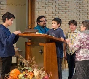 Anthony Biondi Jr., of East Troy, surrounded by family members, gets a view of St. Bernard Church during a stop at the Wauwatosa site. 