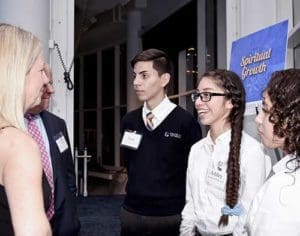 Sophomores Joan Eduardo Macias, left to right, Ashley Perez, and Valeria Paredes spend time sharing experiences with Anne and John O’Connor, and explain what it means to be part of the Cristo Rey Jesuit High School. Macias works at Milwaukee Center for Independence, Perez at Quarles and Brady, LLP and Paredes at Milliman, Inc. (Catholic Herald photo by Juan C. Medina)