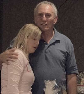 Ron Rowe hugs his niece, Kathy Teofilo, as they announce the total money collected during an Oct. 2 fundraiser at Ledgeview Lanes, Fond du Lac, for the Rowe family. (Submitted photo by Cathy Steffes)