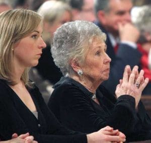 Joan Sheen Cunningham, niece of the late Archbishop Fulton J. Sheen, prays with her family during a 2009 memorial Mass for her uncle at St. Patrick’s Cathedral in New York. The family of Archbishop Sheen has petitioned the Supreme Court of New York state to allow the transfer of the sainthood candidate’s remains to Peoria. (CNS photo/Gregory A. Shemitz)