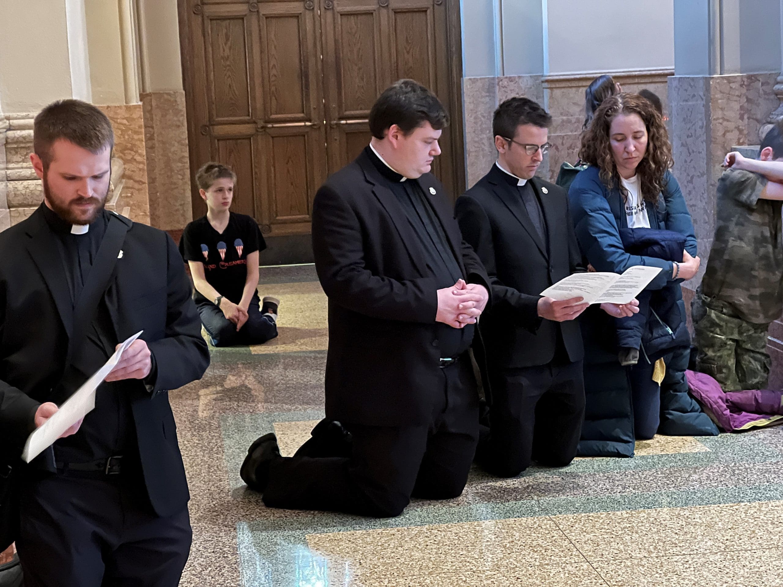 clergy kneeling